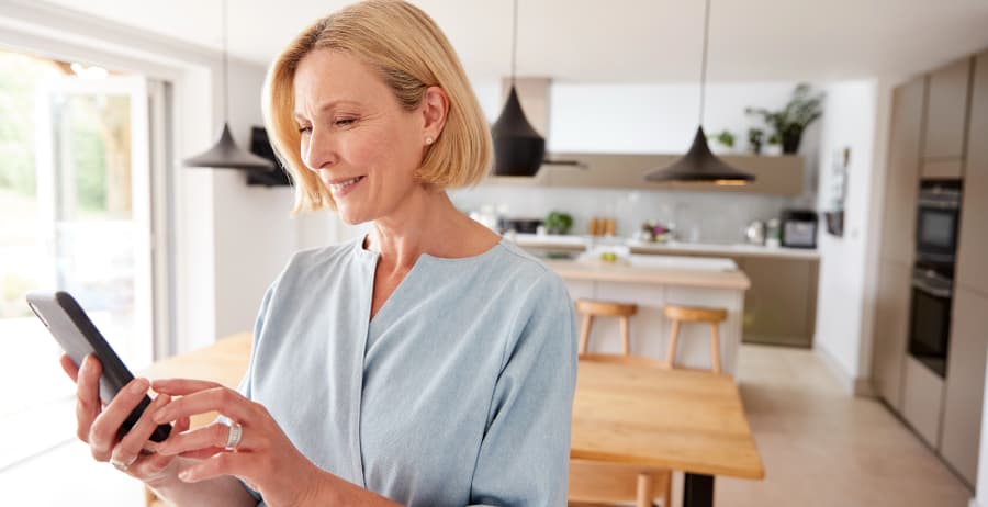 Woman using a smartphone in a modern home